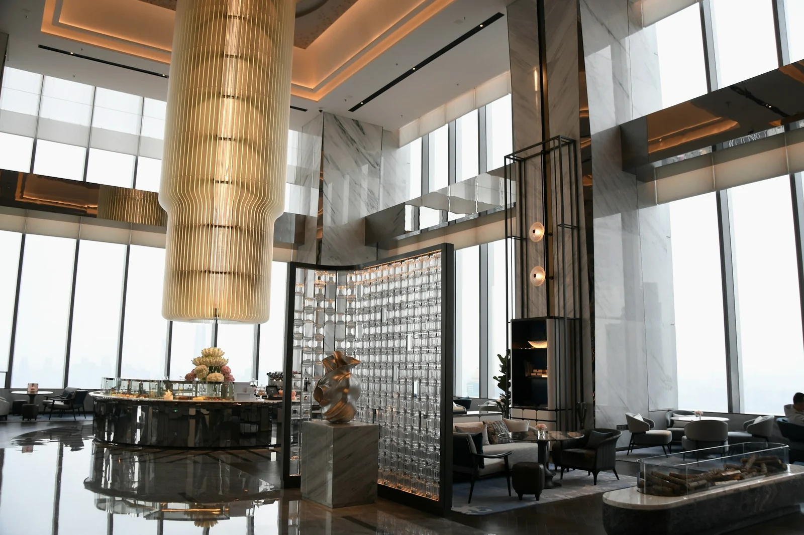 Contemporary luxury hotel lobby with marble and warm lighting