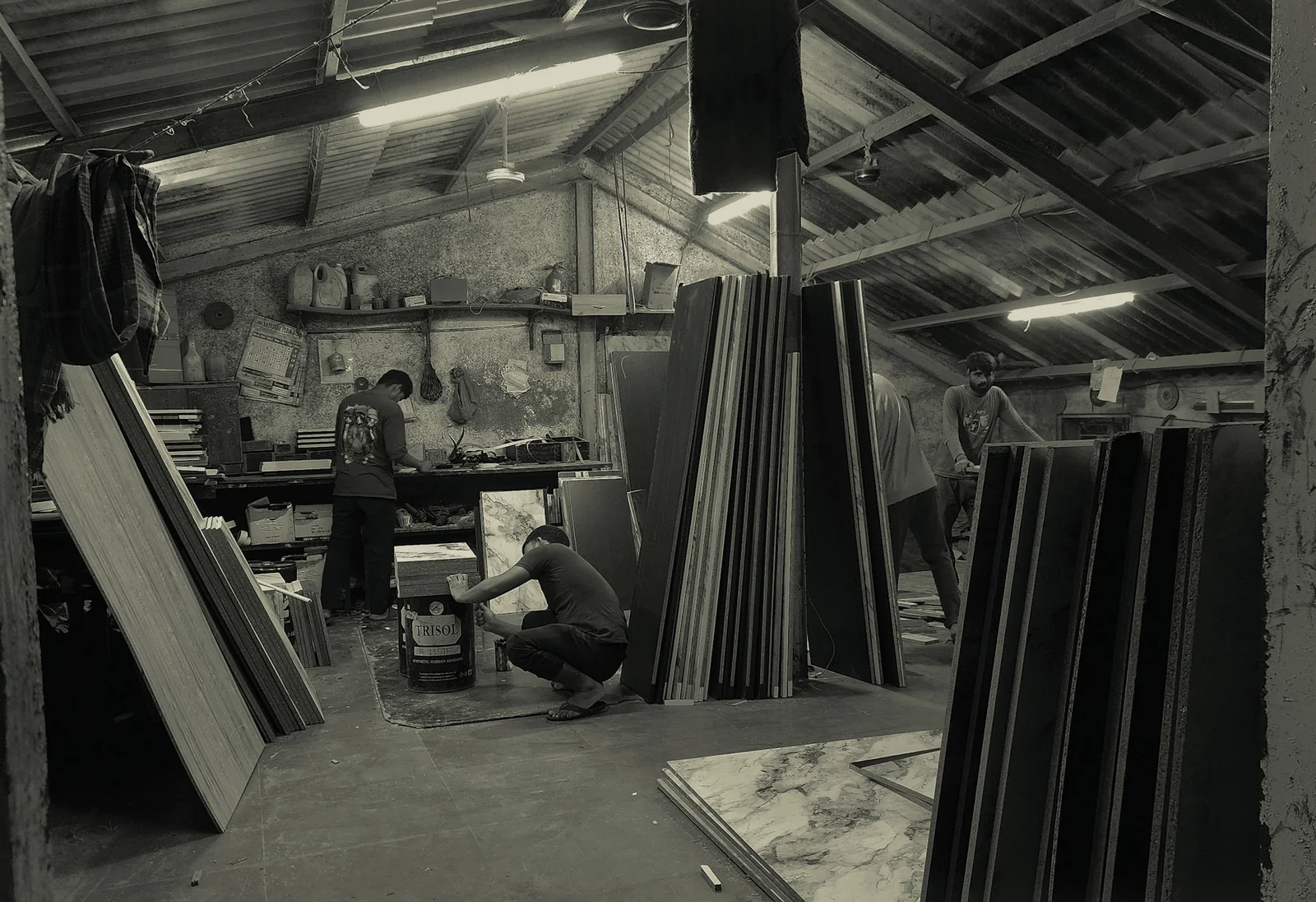 Workers organising materials in a Mumbai workshop