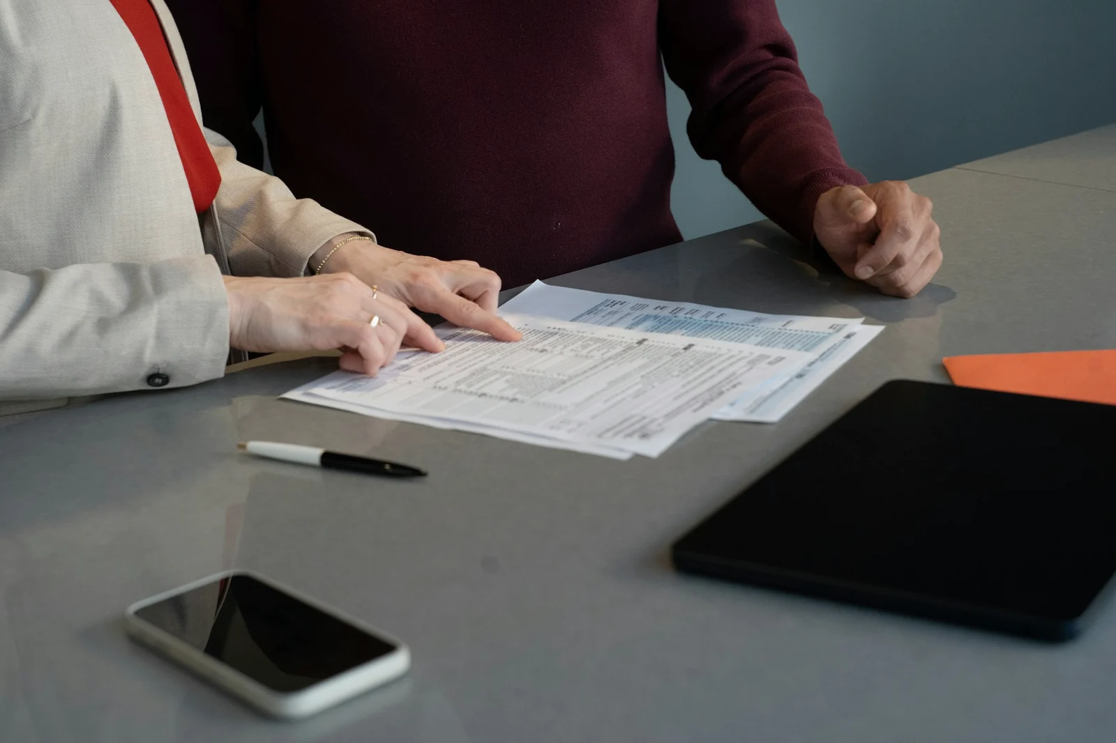 Two advisers reviewing a financial report at a table